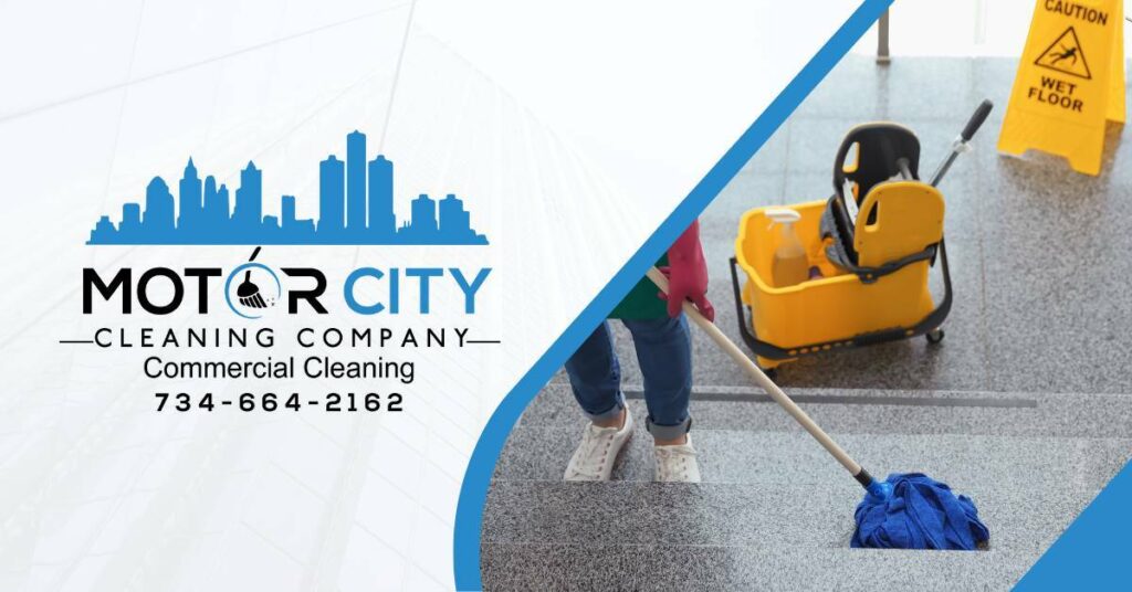 A professional cleaner with a mop and bucket with a caution, wet floor sign cleaning stairs. Commercial cleaning near Ann Arbor, MI | Motor City Cleaning Company